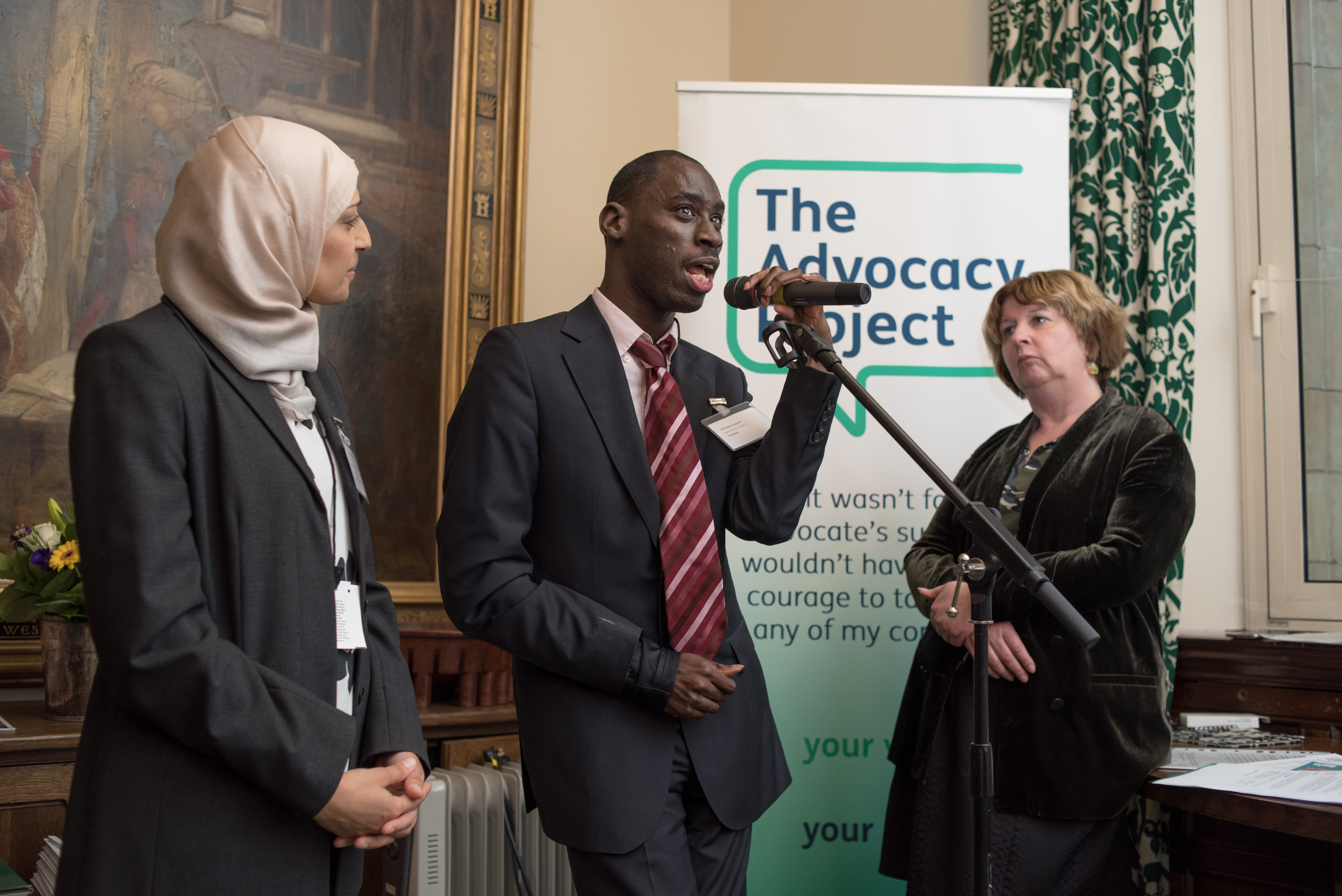 Michael Hagan speaking at the Houses of Parliament, with Karen Buck MP, and Saboohi Bukhari